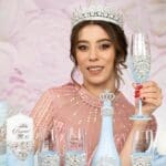 Light blue quinceanera bottle and candle with 4 glasses