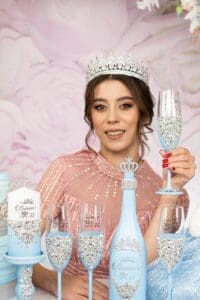 Light blue quinceanera bottle and candle with 4 glasses